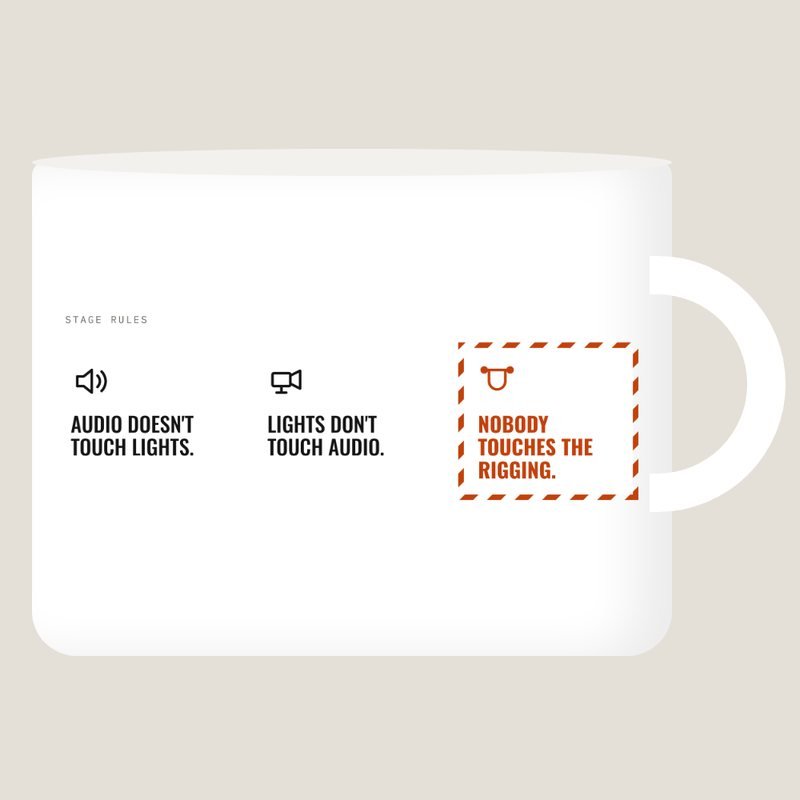 White mug with the stage rules: audio doesn't touch lights, lights don't touch audio, nobody touches the rigging.